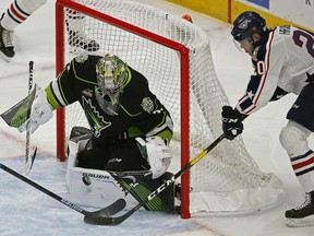 Edmonton Oil Kings goalie Sebastian Cossa (left) makes a save on Tri-City Americans Krystof Hrabik (right) during WHL hockey game action in Edmonton on Nov. 11, 2019. Cossa made 28 saves in an 8-3 win against the Red Deer Rebels.