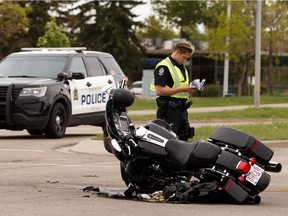Edmonton Police Service officers investigate a crash involving a motorcycle and a Toyota Highlander at 50 Street and 94B Avenue on Monday, June 1, 2020.