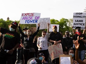 Demonstrators cheer during the A Fight for Equity rally at the Alberta Legislature in Edmonton, on Friday, June 5, 2020. The demonstration follows worldwide Black Lives Matter protests set off by the May 25 death of George Floyd in Minneapolis, Minnesota. Police officer Derek Chauvin has been charged with murder after Floyd died during an arrest where Chauvin knelt on his neck for nine minutes.