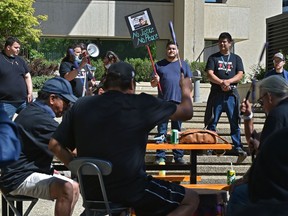 Family and friends of Jake Sansom and Morris Cardinal protest outside the courthouse in Edmonton for the bail hearing for the two men accused in their deaths, June 16, 2020.