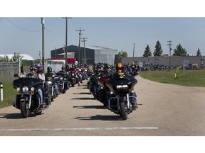 Hundreds of motorcycle riders take part in a memorial ride for Phil Mooney, 39, and Courtney Mooney, 37, who died June 12 in a motorcycle accident.