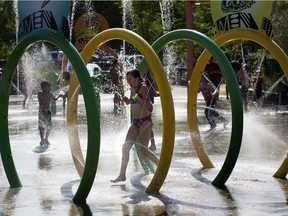 Children enjoy the water at the Jackie Parker spray park on Saturday, June 20, 2020 in Edmonton.  Seven of the city's spray parks opened for the first time this year.