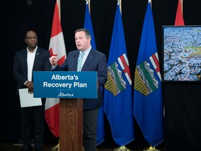 Kaycee Madu, Minister of Municipal Affairs (left) and Premier Jason Kenney at an announcement of provincial funding for upgrades to Terwillegar Drive in Edmonton, Wednesday, July 8, 2020.