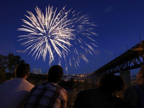 Fireworks explode above the North Saskatchewan River near the High Level Bridge for Canada Day in Edmonton.