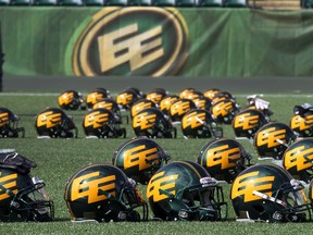 Helmets sit on the sidelines during the Edmonton Eskimos' practice at Commonwealth Stadium in 2014. Calls have grown for the Eskimos to change its name.