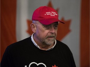 Wearing a 'Make Trudeau A Drama Teacher Again' hat and an 'I Heart Canadian Oil and Gas' t-shirt, Paul Bunner, president of the Edmonton Strathcona Conservative Association, watches the early federal election results at the Lyon restaurant, 10335 83 Ave., in Edmonton on Oct. 21, 2019. The restaurant was hosting the election night event for Edmonton-Strathcona Conservative Party of Canada candidate Sam Lilly.