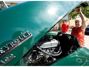 Marilyn Huff shows off the engine in her 1953 Chevy pickup truck as members of the Edmonton Antique Auto Club prepare to hold a Father's Day parade for seniors, near the Northgate Lions Seniors Recreation Centre, 7524 139 Ave., in Edmonton Friday June 19, 2020. Photo by David Bloom