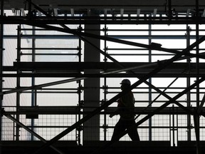 A worker walks through scaffolding in the Stantec building's lobby during a construction media tour of ICE District's latest developments: Edmonton Tower, JW Marriott Hotel-Legends Private Residences and Stantec Tower and SKY Residences in Edmonton, Alberta on Tuesday, September 12, 2017.