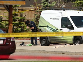 An Edmonton Police Service officer investigates a suspicious death outside the Brintnell Place apartment complex on June 13, 2020.