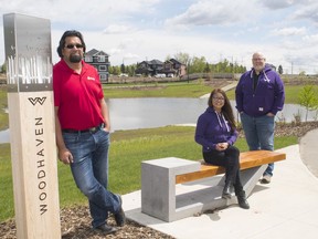 Rohit Gupta, president of Rohit Group of Companies, along with project manager Leanne Ure and vice-president of development Russell Dauk VP at Woodhaven Edgemont, named Best New Community.