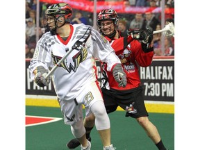 Wings Cory Vitarelli looks for an open pass while Roughnecks Greg Harnett keeps the pressure on during the 1st half of NLL action as the Calgary Roughnecks host the Philadelphia Wings at the Saddledome on Saturday, December 28, 2019. Brendan Miller/Postmedia