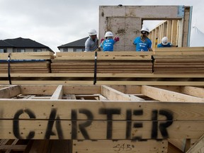 Volunteers work on a Habitat for Humanity site near 22 Avenue and 24 Street, in Edmonton Monday July 10, 2017. File photo.