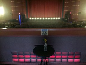 The current pandemic reality of seeing movies in theatres: forbidden seats and hand sanitizer.