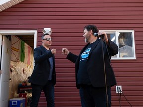 Comics Lars Callieou (left) and Norm Shaw perform in an Edmonton homeowner's backyard during a stop on their Firepit Comedy Tour.