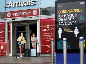 Passengers wearing protective masks are pictured after arriving at Birmingham Airport following the outbreak of the coronavirus disease (COVID-19) in Birmingham, Britain July 27, 2020.