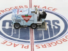 A Zamboni driver wearing a face mask floods the ice during the first day of the Edmonton Oilers training camp for the 2019-20 NHL return to play venture at Rogers Place on July 13, 2020.