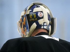A No. 12 sticker is visible on Edmonton Oilers goaltender Mikko Koskinen's helmet in honour of former teammate Colby Cave during a training camp scrimmage in Edmonton on Wednesday, July 22, 2020.