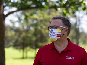 Jim Gibbon, executive director of the Edmonton Heritage Festival, models his organization's COVID-19 masks, while speaking about the festival going online in the month of August, July 29, 2020 in Hawrelak Park.