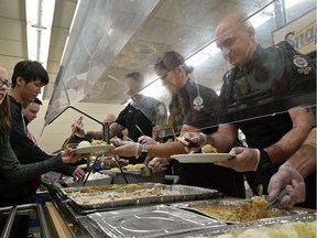 Teachers and police officers served Christmas dinner at L.Y. Cairns School on Thursday December 19, 2019. The annual Christmas feast for 400 students started at L.Y. Cairns School 50 years ago and was served by staff and school resource officers from the Edmonton Police Service.