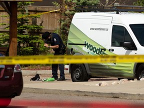 An Edmonton Police Service officer investigates a suspicious death in the parking lot of the Brintnell Place apartment complex in Edmonton, on Saturday, June 13, 2020. Photo by Ian Kucerak/Postmedia