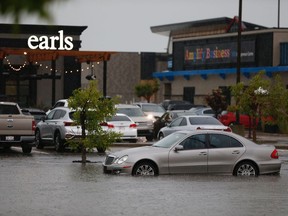 A parking lot in south Edmonton flooded after an intense storm swept through the capital region with heavy rain, some hail and winds on Thursday, July 16, 2020.