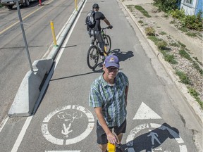 Paths for People chairman Dave Buchanan by a protected bike lane on the north side of 105 Avenue/110 Street. Paths for People is calling for the 105 Ave (Columbia Ave) construction project to be paused because it will remove the protected bike lanes and make the street less safe for cyclists on July 17, 2020.