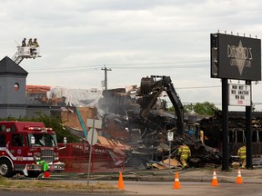 Cleanup begins after Edmonton Fire Rescue Services firefighters extinguished a morning fire at Diamonds Gentlemen's Club in Edmonton, on Thursday, July 23, 2020. The building was closed due to a previous fire.