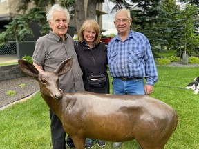 Barry Schloss and wife Maureen, seen here with renowned Cochrane artist Don Begg, have placed a bronze sculpture outside their new home on Saskatchewan Drive. The work is so perfect other deer have sought intimate relations with it. SUPPLIED