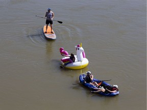 A group of people float down the North Saskatchewan River in kayak, a standup paddle board and an inflatable unicorn as they enjoy the warm summer day near Hawrelak Park on Wednesday, July 29, 2020 in Edmonton.