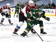 Erik Johnson #6 of the Colorado Avalanche pressured Marcus Foligno #17 of the Minnesota Wild during the third period of the exhibition game prior to the 2020 NHL Stanley Cup Playoffs at Rogers Place on July 29, 2020 in Edmonton.