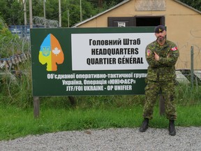 Lt-Col. Ryan Stimpson, the commanding officer of Operation UNIFIER poses for a photo at the gate of the Canadian compound at the International Peacekeeping and Security Center in Lviv Oblast, Ukraine July 19, 2020.
