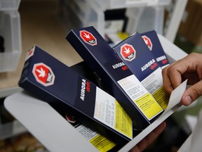 An employee holds a tray of Aurora Cannabis Inc. Drift brand edibles inside the Hobo Cannabis Co. store in Ottawa.