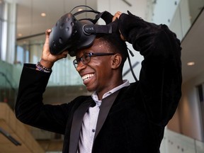 Simba Nyazika, Lenica's founder and CEO, poses for a photo with a HTC Vive virtual reality headset at the company's offices in Edmonton, on Wednesday, July 22, 2020. Lenica has developed a VR cognitive technology that will help athletes build their dexterity and reaction time. Photo by Ian Kucerak/Postmedia