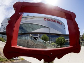 Rogers Place is framed by part of a public sculpture titled Still Life by Studio F Minus, in Edmonton Monday June 8, 2020.