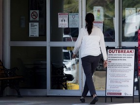 A woman enters the Good Samaritan Society Southgate Care Centre, 4225 107 St., in Edmonton Wednesday July 29, 2020. Several deaths have now been linked to a COVID-19 outbreak at the care home. Photo by David Bloom