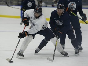 Connor McDAvid chases after Andreas Athanasiou during dDay 2 of the Edmonton Oilers return-to-play camp at the Downtown Community Arena on Tuesday, July 14, 2020.