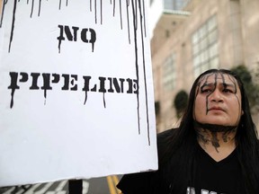 People protest against President Donald Trump's executive order fast-tracking the Keystone XL and Dakota Access oil pipelines in 2017.