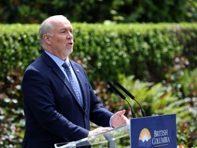 B.C. Premier John Horgan provides the latest update on the COVID-19 response in the province during a press conference from the rose garden at Legislature in Victoria, B.C., on Wednesday, June 3, 2020. Horgan says those who have offshore licence plates on their vehicles while driving in the province should take the bus or ride a bicycle if they're feeling harassed by the public.
