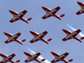The Snowbirds fly over Portsmouth Olympic Harbour in during their cross-country tour in Kingston, Ont. on Friday, May 8, 2020.