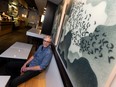 Credo owner Geoff Linden with Jeff Sylvester's art at the cafe's 10134 104 St. location.