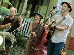 Elliot Thomas, left, Pamela Mae and Scott Cook performing in a yard concert in Cloverdale in 2020. Despite taking another pandemic break this August, the Edmonton Folk Music Festival will be putting on a series of small, scattered concerts over four weekends starting July 16.