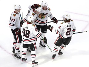 Dominik Kubalik of the Chicago Blackhawks is congratulated by teammates Jonathan Toews, Patrick Kane, Kirby Dach and Duncan Keith after Kubalik scored on a power play in the second period during Game One of the Eastern Conference Qualification Round prior to the 2020 NHL Stanley Cup Playoffs at Rogers Place, Aug. 01, 2020.