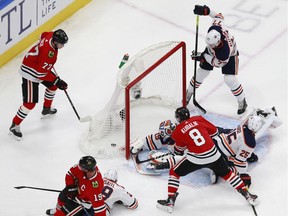 Mikko Koskinen #19 of the Edmonton Oilers allows a goal to Jonathan Toews #19 of the Chicago Blackhawks during the first period in Game 3 of the Western Conference Qualification Round at Rogers Place on August 05, 2020.