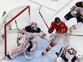 Mikko Koskinen of the Edmonton Oilers tends net against Kirby Dach of the Chicago Blackhawks in Game 4 of the Western Conference Qualification Round prior to the 2020 NHL Stanley Cup Playoffs at Rogers Place in Edmonton on Friday, Aug. 7, 2020.