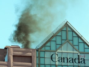 Black smoke billows from the roof of Canada Place late Sunday afternoon. Fish Griwkowsky/Postmedia