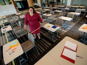 Alberta NDP Education Critic Sarah Hoffman poses in a makeshift classroom, created to illustrate the difficulties teachers and students will face in observing COVID-19 social distancing rules during a return to school this fall, in Edmonton Tuesday Aug. 11, 2020.