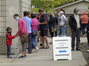 People lined up outside a COVID-19 drop-in testing centre in Edmonton on June 3, 2020.