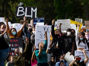 Demonstrators cheer during the A Fight for Equity rally at the Alberta legislature in Edmonton on June 5, 2020.