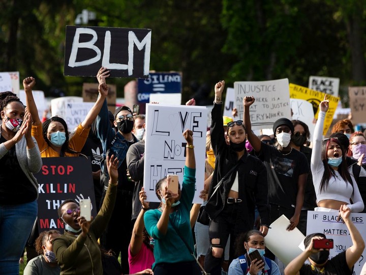  Demonstrators cheer during the A Fight for Equity rally at the Alberta legislature in Edmonton on June 5, 2020.