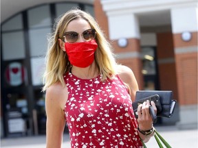 Allison Mones walks out of the downtown Safeway wearing a mask as face coverings became mandatory in Calgary on Aug. 1, 2020.